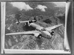 Aerial view of Lockheed Hudson aircraft over mountain ranges