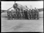 Group of unidentified Royal New Zealand Air Force personnel, standing in front of an aeroplane, Ardmore Air Force Base, Auckland