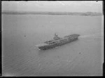 The HMS Glory Aircraft Carrier with planes and trucks on deck, [Auckland?] Harbour