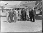 Fraser, Rt Hon Prime Minister at Whenuapai prior to departing for England by RAFTC [Royal Air Force Technical College], DC4 aircraft. With L to R (two unknowns) - E.A. Robinson, General Commander C.C Hunter, Brigadier. Williams, A.D McIntosh, Squadron Leader J. Adams, Leo White, W.J. Jordan