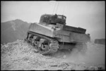 NZ Sherman tank takes up position in a ruined village in the Cassino front line area, Italy, World War II - Photograph taken by George Kaye