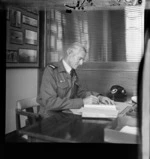 Sir Keith Park, seated at desk, writing