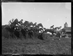 Steeple chase at Ellerslie Race Course, Auckland, includes race horses and jockeys