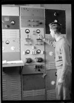 B V Richards, checking transmission instruments, Musick Point Air Radio Station, Howick, Auckland