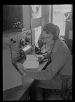 R D Goodman, listening to transmissions through headphones, Musick Point Air Radio Station, Howick, Auckland
