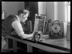 N Grewell-Cooke, testing a receiving set of transmission instruments, Musick Point Air Radio Station, Howick, Auckland
