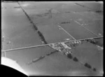 The Ruawai Dairy Factory and a few houses surrounded by farmland, Ruawai, Kaipara Harbour, Northland Region