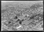 Epsom Girls' Grammar School with Manukau Road in foreground with Ambury's Ltd milk bottling factory, looking west to Mt Eden, Auckland City