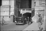 Prime Minister Peter Fraser in Vatican car, to attend audience with Pope, passes Swiss guards, Italy, World War II - Photograph taken by George Bull