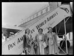 Portrait of (L to R) Miss Helen Desha, Mrs Marion Desha and Miss Nina Desha in front of a Clipper Class Pan American World Airways aeroplane and gangway, Whenuapai Airfield, Auckland