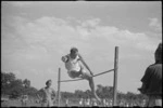 Second Lieutenant C Baker clearing the high jump bar at 5 NZ Field Regiment Gymkhana, Arce, Italy, World War II - Photograph taken by George Bull