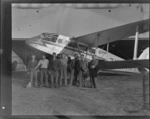 Unidentified staff members of Air Travel Limited, Hokitika, in front of a De Havilland DH89 Rapide aircraft 'Tareke' ZK-AKT