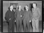 Group portrait at a Royal NZ Aero Club Annual Meeting of (L to R) Mr R T Cadwallader, Mr H Christie (Canterbury), Mr W Sexton (Auckland) and Mr N McLaren (Nelson), in front of an unknown building, [Auckland City?]