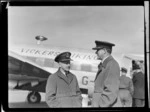 View of (L to R) Group Captains T W White and C Kay in RNZAF uniforms in front of visiting British Vickers Viking passenger plane G-AJJN, [Whenuapai Airport, Auckland City?]