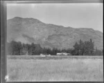 An Auster ZK-AOB airplane, on a field, Queenstown, including hills in the background