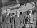Mr R A Phillpots (Bank of New South Wales) (from left), N McDonald (Kaikohe Hotel) and L Mehrtens (Bank of New Zealand), in front of a Bristol Freighter aircraft
