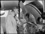 Mr M F Elliott being presented with miniature pois by guide Emily, at the Bristol Freighter Tour, Rotorua, Bay of Plenty region