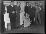 Group of unidentified men, with Miss Kelsey bowling while kneeling, at an Auckland Aero Club dinner, Auckland
