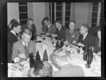 Group of unidentified men, including youths, seated at tables and eating, during an Auckland Aero Club dinner, Auckland