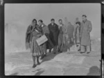 Unidentified members of Bristol Freighter crew, with guide Rangi, walking along hot thermal springs and bubbling mud pools, Rotorua, Bay of Plenty