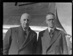 Portrait of Canterbury Aero Club members (L to R) H D Christie (President) and A George (Secretary) in front of a plane, Harewood Airport, Christchurch City