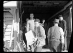 Bristol Freighter Tour, view of unidentified men unloading freight from the cargo bay of Bristol Freighter transport plane 'Merchant Venturer' G-AIMC, Woodbourne Airport, Blenheim District, Marlborough Region