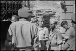 Two prisoners taken by 22 NZ Battalion are brought into Rimini, Italy, during World War II - Photograph taken by George Kaye