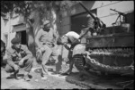World War II New Zealand soldiers make adjustment to their Bren carrier in Rimini, Italy - Photograph taken by George Kaye