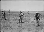 Locals carrying spraying equipment in anti malaria campaign in Syria, World War II - Photograph taken by H Paton