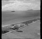 View of the settlement of Tauranga Taupo with houses on Waitetoko Road to Motutaiko Island beyond, eastern side of Lake Taupo