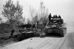 Kaye, George, b 1914- : NZ tank passing out a knocked out German tank, across the Senio River