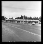 Shopping area, Main Road, Paraparaumu, Kapiti Coast district, showing business premises including SA Kerr Ltd, Norman's Drapery, Keogh's Bookshop, and Param Gift Store