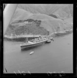 Ship 'Rangatira', owned by the Union Steamship Company, run aground at the entrance to Tory Channel, Marlborough District, with tugboat 'Tapuhi'