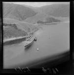 Ship 'Rangatira', owned by the Union Steamship Company, run aground inside entrance of Tory Channel, Marlborough District, with tugboat 'Tapuhi'