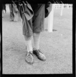 Unidentified man lifting his trouser legs to show mismatched socks, Trentahm Racecourse, Upper Hutt