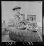 Mr M G Luckon with mountain goat horns tired to the bonnet of his Land Rover at an unknown location, probably Wellington Region