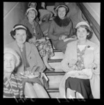 Group of unidentified women sitting on a staircase, eating a meal, at Sir Truby King's house, Melrose, Wellington