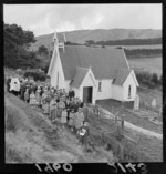 The Holy Trinity Church with unidentified priest and local congregation in front at the rural settlement of Ohariu west of Johnsonville, Wellington City