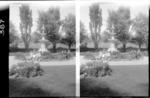 Group of unidentified children sitting beside fountain in the Public Gardens, Oamaru, Otago