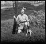 Davidson with dog, and holding dead cat, Raoul Island