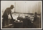 Men working metal, China