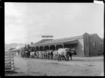 Bullock team and traction engine alongside Oates Brothers store in Tokomaru Bay, East Coast