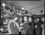 Women in a department store, alongside a display of Serenade beauty creams