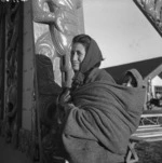 Unidentified Maori woman holding a child on her back, at Te Kaha