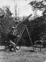 Arthur Samuel Atkinson looking through a telescope
