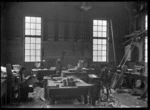 Man reading in a carpenters' workshop