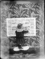 [Edgar Richard Williams?], pointing to a picture of an unidentified church on a Dunedin Union Line poster, on a floral backdrop, location unidentified