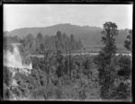 View of the [Whakapapa or Whanganui River?] surrounded by bush and forest, Kakahi Settlement, Manawatu-Whanganui Region