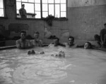 Drivers H R Kelly, K W Hamblyn, S P Parkinson, W T Capper and B C Marychurch in a hot mineral bath at a staging area on 10 Company's trip to Pusan