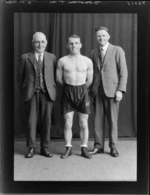 Boxer, Mr T Donovan, with two unidentified men